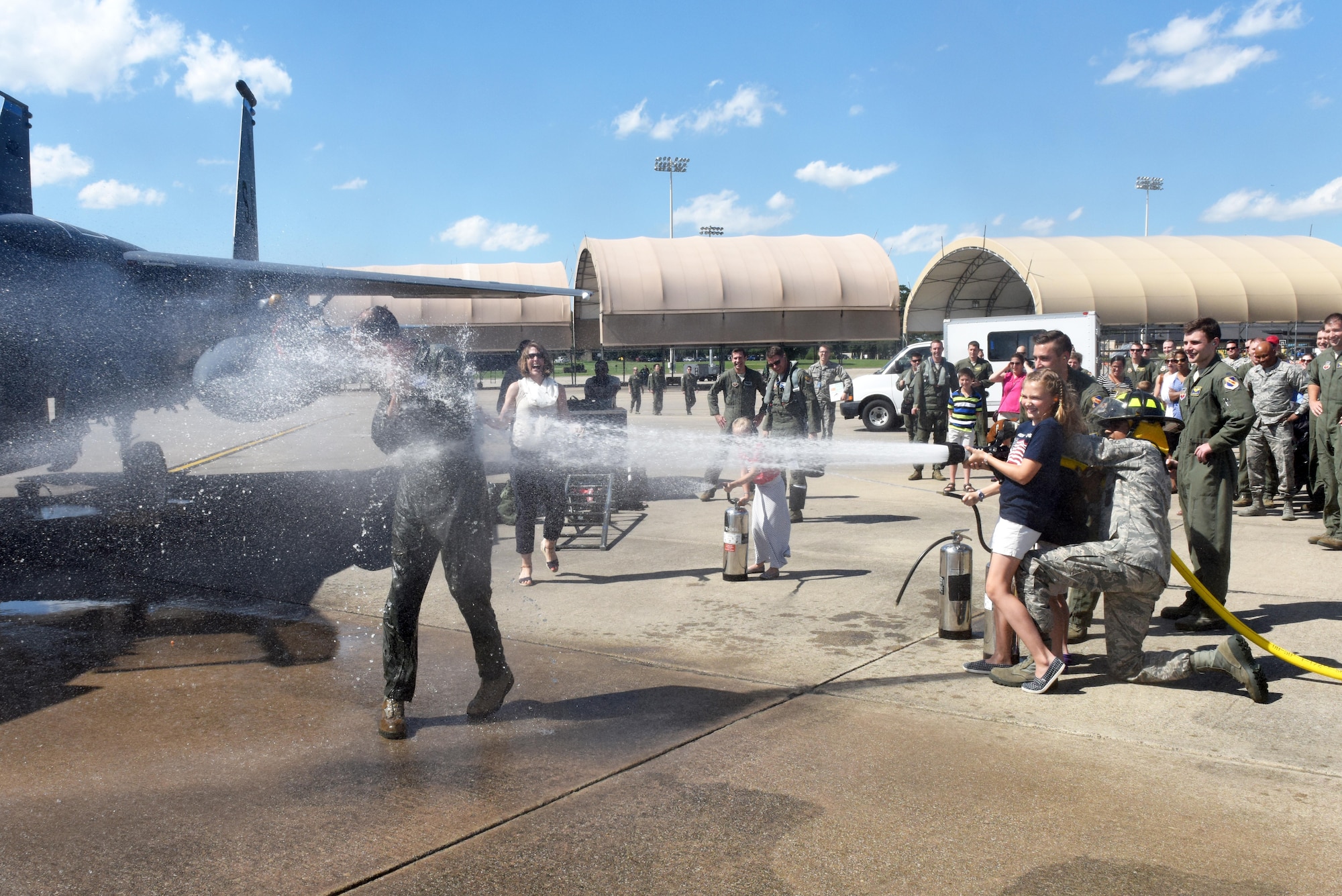 Col. Brian Afflerbaugh, 4th Operations Group commander, is hosed down by his family June 8, 2016, following his final F-15E Strike Eagle flight at Seymour Johnson Air Force Base, North Carolina. Supporters from around the base came to commemorate the moment and thank Afflerbaugh for his contributions to the installation. (U.S. Air Force photo/Tech. Sgt. Chuck Broadway)