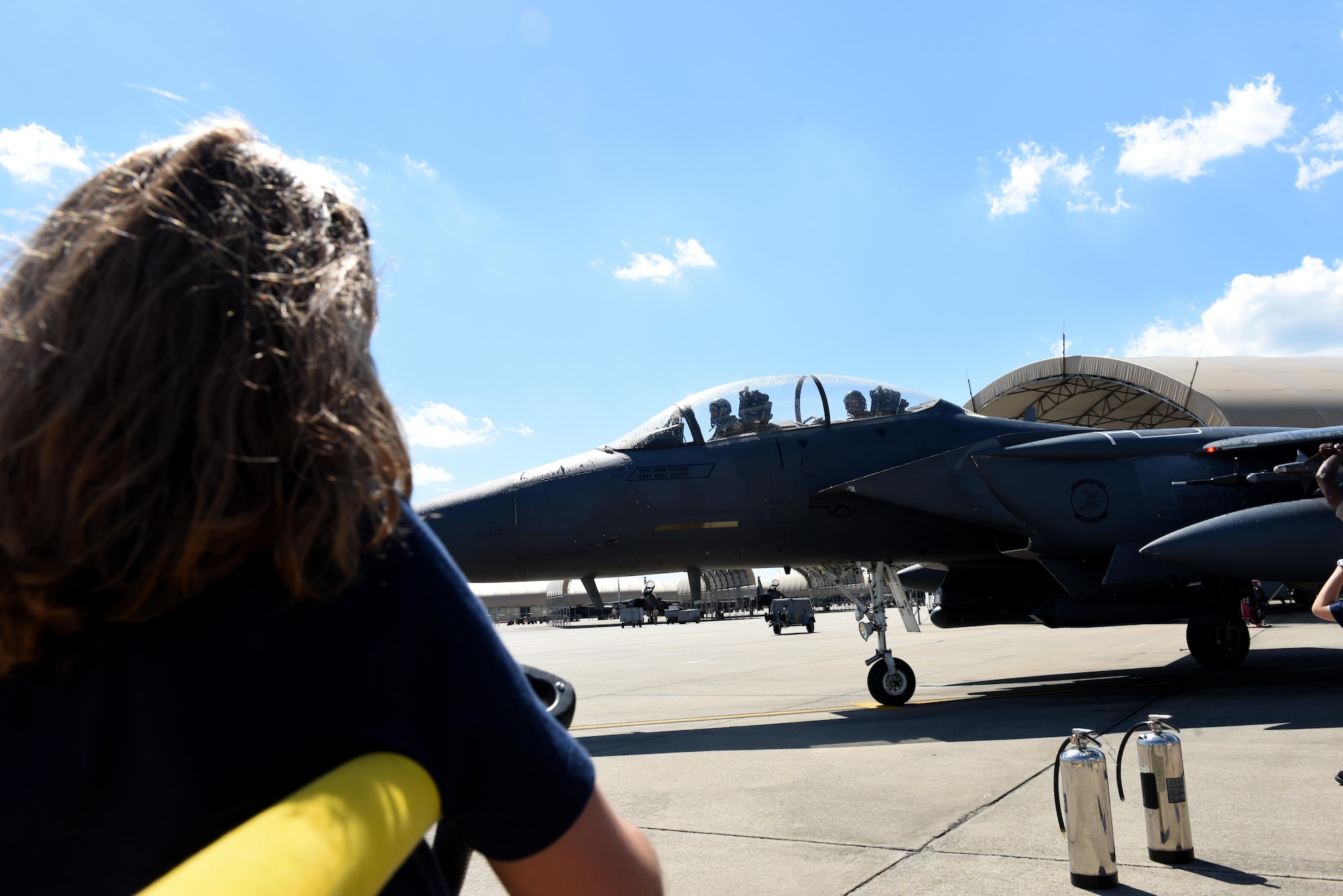 The daughter of Col. Brian Afflerbaugh, 4th Operations Group commander, prepares to spray her father following his final flight June 8, 2016, at Seymour Johnson Air Force Base, North Carolina. Afflerbaugh will leave his current position and fill a position at Osan Air Base, Republic of Korea. (U.S. Air Force photo/Tech. Sgt. Chuck Broadway)