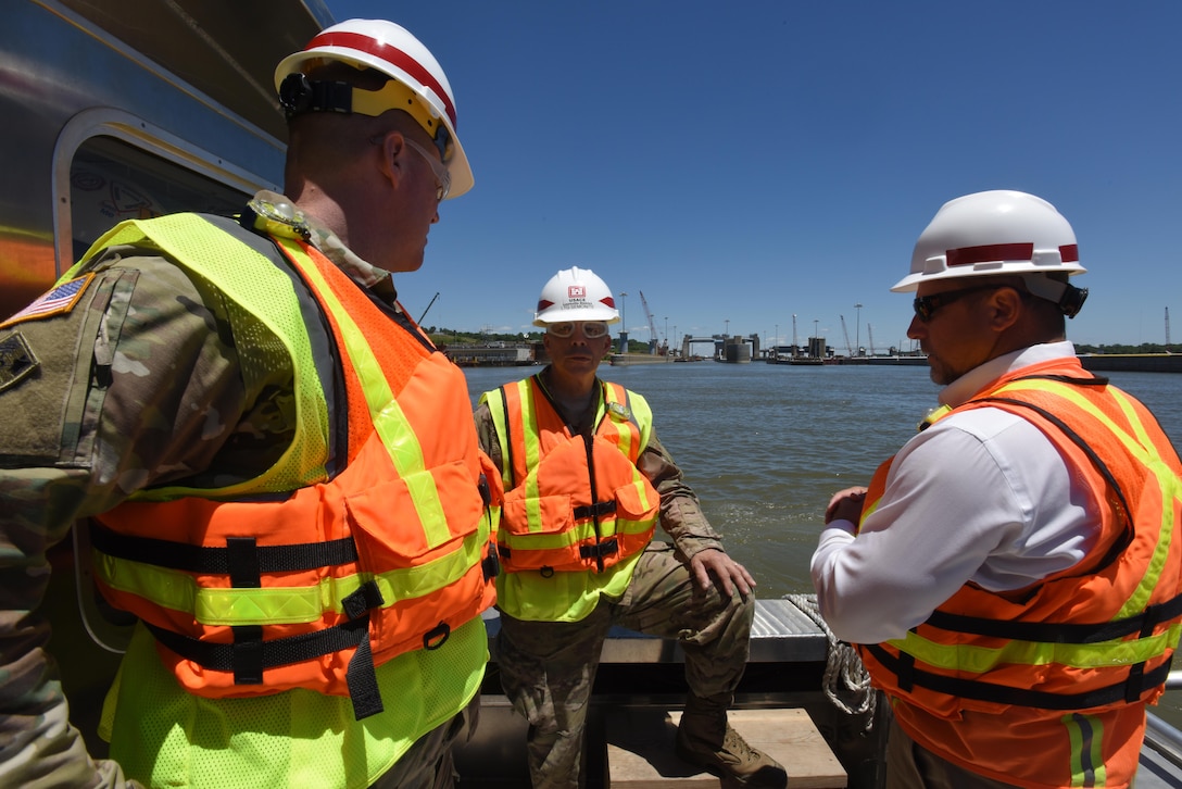 Lt. Gen. Todd T. Semonite (Center), U.S. Army Corps of Engineers commander and chief engineer, tours the Olmsted Lock and Dam project on a vessel in the Ohio River June 7, 2016.  Col. Christopher Beck (Left), Louisville District commander, and Mick Awbrey, deputy chief of the Olmsted project, brief the general on the ongoing construction work.
