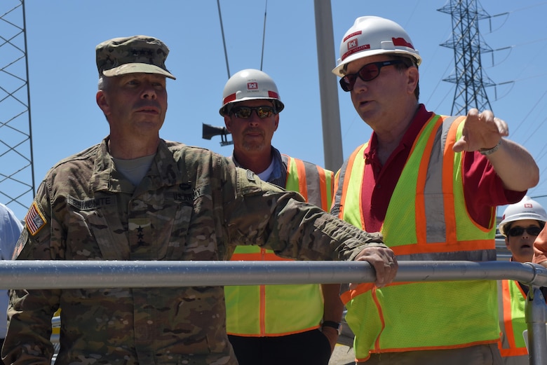 Lt. Gen. Todd T. Semonite (Left), U.S. Army Corps of Engineers commander and chief of engineers, looks at the Kentucky Lock Addition Project from a vantage point above the construction during a visit to the project in Grand Rivers, Ky., June 7, 2016. Project Manager Don Getty points out the activities at the project site and updates the general on the progress of construction.
