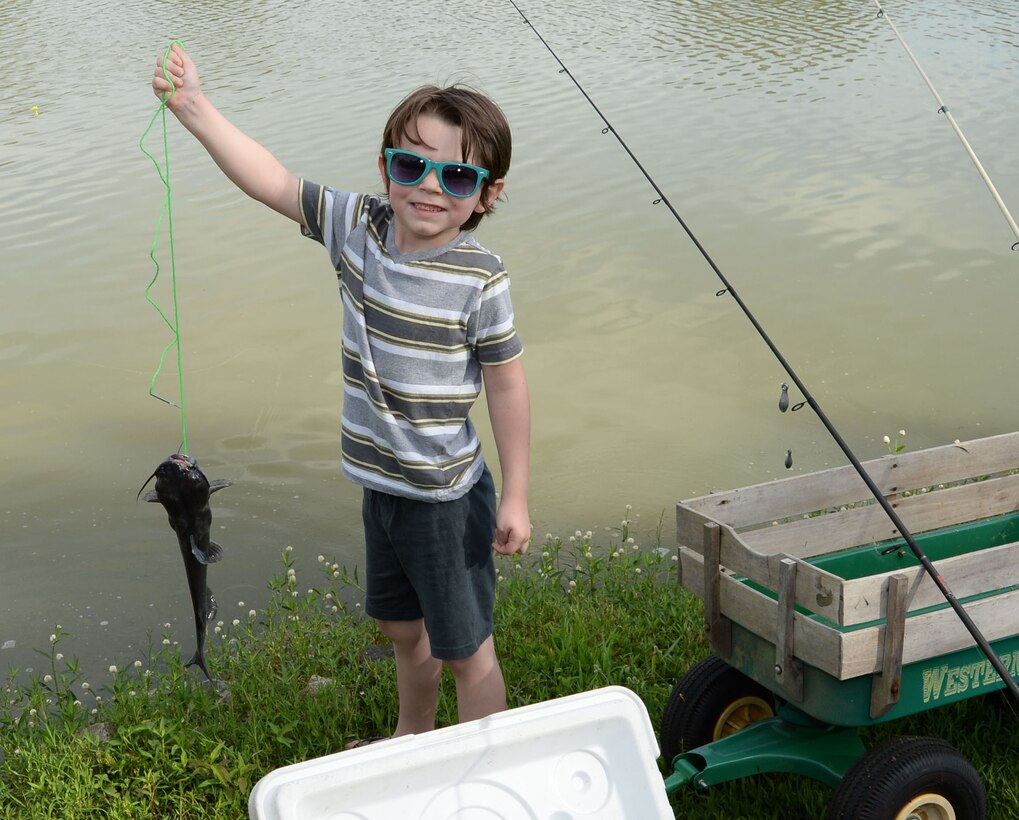 Four-year old Gavin Frakes shows off the catfish, which wins him a trophy at the 28th Annual Buddy Fishing Tournament at Marine Corps Logistics Base Albany, June 4. At the weigh in, Gavin walked away as the event’s overall biggest catch-of-the-day winner with his 1.4 pound catfish.

