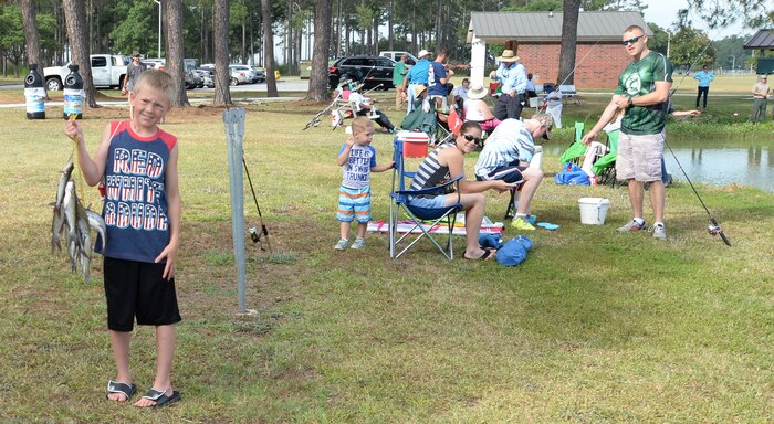 One young angler participating in the 28th Annual Buddy Fishing Tournament at Marine Corps Logistics Base Albany, June 4, shows off his string of fish. The event, held at Covella Pond, here, is opened to community youth 15 years and younger. At the weigh in, several trophies were awarded for the biggest fish in various age groups at the end of the tournament.
