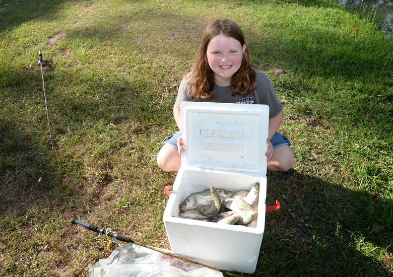 Veteran fisherman, nine-year old Gabby Usry, displays her cooler full of fish at the 28th Annual Buddy Fishing Tournament at Marine Corps Logistics Base Albany, June 4. The event, held at Covella Pond, was opened to community youth 15 years and younger. Gabby, who came to the event with her grandfather, Brad Usry, said it was not her first time fishing, but it was her first time participating in the "buddy" tournament on the base.
