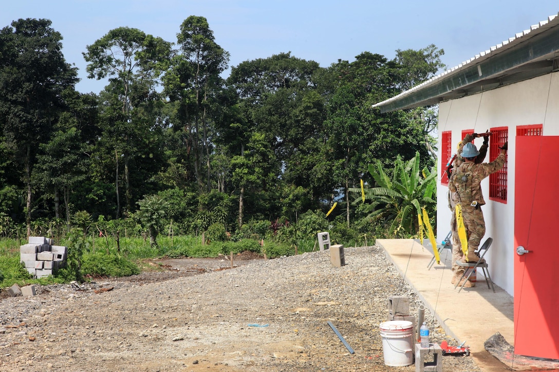 Soldiers paint the outside window frames as they finish a new school for Guatemalan children during Beyond the Horizon 2016 in Tocache, Guatemala, June 2, 2016. Army photo by Spc. Tamara Cummings