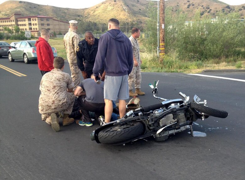 U.S. Marine Sgt. Brandon Jackson is treated for injuries sustained in a motorcycle accident by corpsmen aboard Camp Pendleton, Calif., May 23, 2016. Jackson, an airframes mechanic instructor at the Center for Naval Aviation Technical Training,was on his daily commute to work when he collided with a passenger vehicle. He sustained only minor injuries in the accident. (Courtesy Photo)
