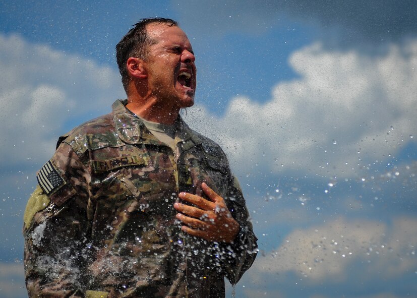Col. Sean Farrell, commander of the 1st Special Operations Wing, is sprayed with water at Hurlburt Field, Fla., June 7, 2016. Farrell is scheduled to relinquish command of the 1 SOW during a change of command ceremony here, June 10, 2016. (U.S. Air Force photo by Airman 1st Class Joseph Pick)