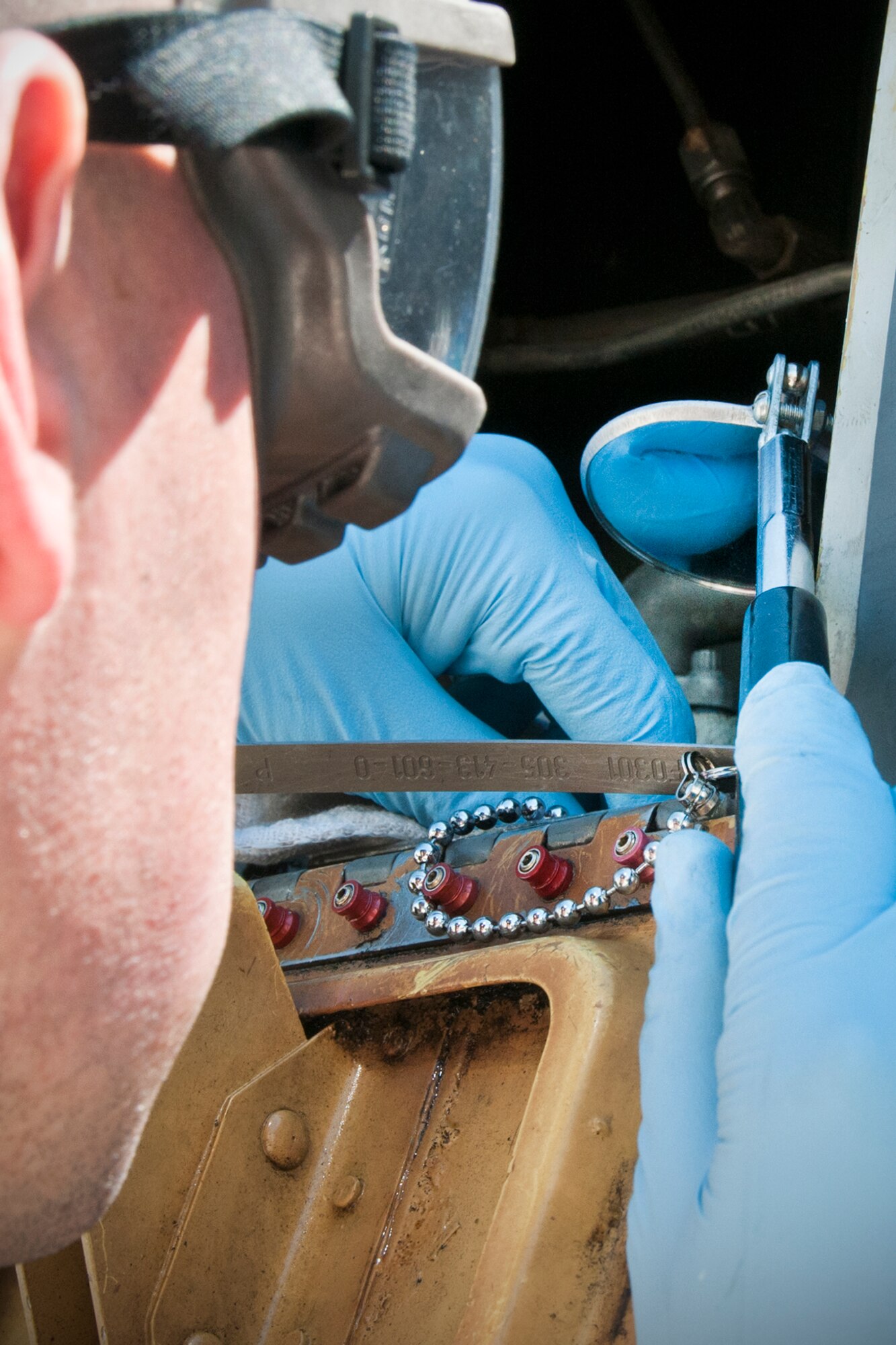 Staff Sgt. Dustin Brown, 459th Aircraft Maintenance Squadron crew chief, uses a mirror to check the oil level on the engine of a KC-135R Stratotanker on the Joint Base Andrews, Md., flight line June 9, 2016. The aircraft had just returned from Turkey, where it provided refueling support as part of Operation Inherent Resolve. (U.S. Air Force photo/Staff Sgt. Kat Justen)  