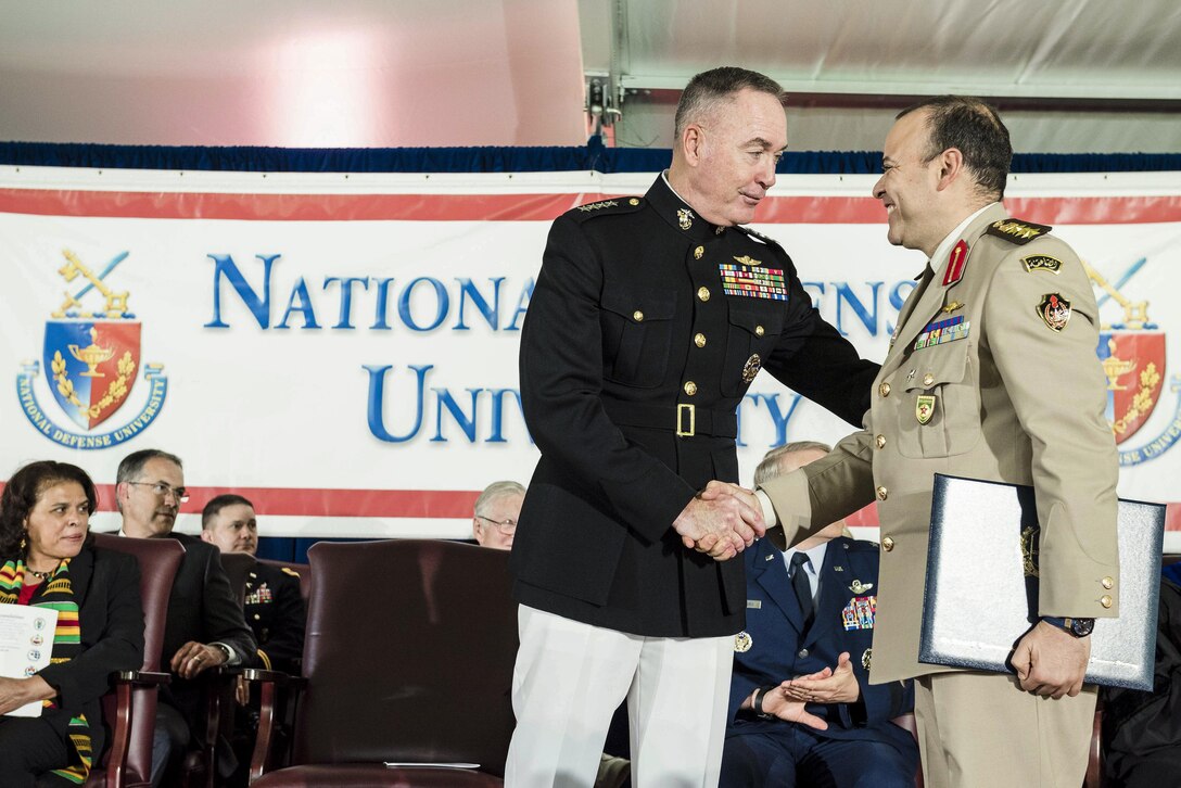 Marine Corps Gen. Joe Dunford, chairman of the Joint Chiefs of Staff, shakes hands with a graduate during the National Defense University's 2016 graduation ceremony at Fort Lesley J. McNair in Washington, D.C., June 9, 2016. The university provides military education to senior leaders of the U.S. armed forces. DoD photo by Army Staff Sgt. Sean K. Harp


