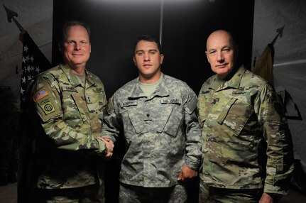 Maj. Gen. Duane A. Gamble, commander of the 21st Theater Sustainment Command, and Command Sgt. Maj. Stanley O. Richards, Interim Command Sergeant Major of the 21st TSC, pose with Spc. Daniel F. Kovitch, with the 412th Engineer Company, after presenting him with a commanders coin during Anakonda 2016, in Warsaw, Poland, June 9. Anakonda 2016 is one of U.S. Army Europe's premier multinational training events, which features 24 nations and seeks to train, exercise and integrate Polish national command and force structures into an allied, joint, multinational environment. (U.S. Army photo by Sgt. Kayla F. Benson, 96th Sustainment Brigade)