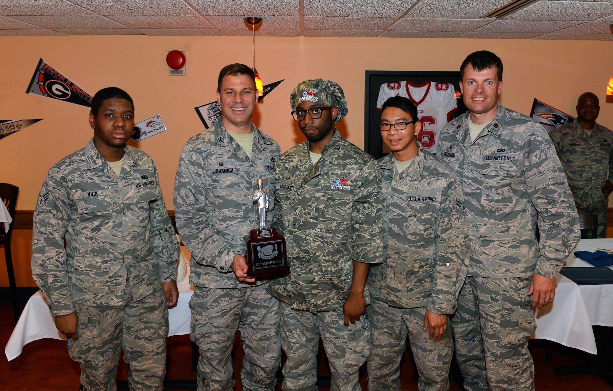 U.S. Air Force Col. Mathew Joganich, commander of the 55th Mission Support Group, poses with the winning team of the first Iron Chef Competition at the Ronald L. King Dining Facility on June 2, Offutt Air Force Base, Neb.  The two teams competing in the Iron Chef Competition were comprised of Airmen representing both King Dining Facility and the Campisi Alert Kitchen.  (U.S. Air Force photo by Josh Plueger/Released)