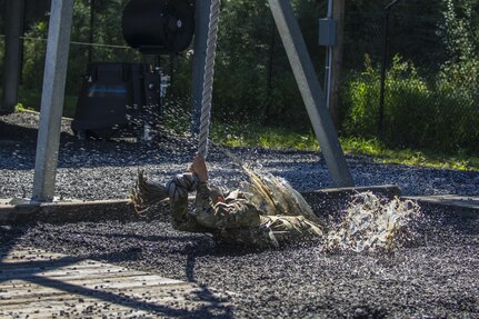 Before tackling the 40-foot wall at Victory Tower, Soldiers in Basic Combat Training with Co. A, 2nd Bn., 13th Inf. Reg. at Fort Jackson, S.C., practice swinging across their drill sergeant's lava pit on the ground, June 8. Sometimes they make it, sometimes they don't. (U.S. Army photo by Sgt. 1st Class Brian Hamilton/ released)