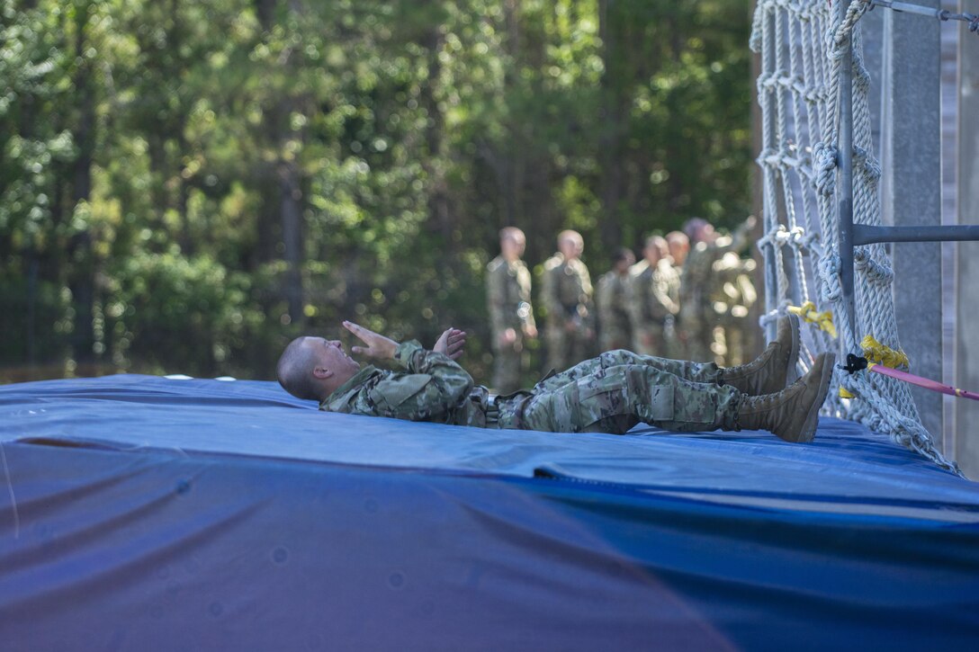 Soldiers in Basic Combat Training with Co. A, 2nd Bn., 13th Inf. Reg., roll off of the mats after climbing down 30-feet on a cargo net on Victory Tower at Fort Jackson, S.C., June 8. (U.S. Army photo by Sgt. 1st Class Brian Hamilton/ released)