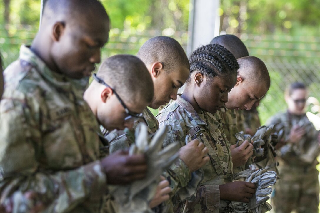 Soldiers in Basic Combat Training with Co. A, 2nd Bn., 13th Inf. Reg., inspect thier gloves and equipment in preparation for the repel tower at Fort Jackson, S.C., June 8. (U.S. Army photo by Sgt. 1st Class Brian Hamilton/ released)