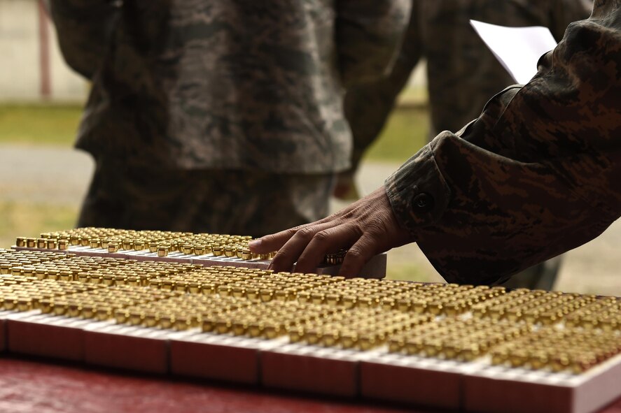 Competitors grab their M9 pistol ammunition for the Excellence-in-Competition event June 2, 2016, at the range at Joint Base Lewis-McChord, Wash. This was the first time the EIC has been held at JBLM. (U.S. Air Force photo/Tech. Sgt. Tim Chacon)  
