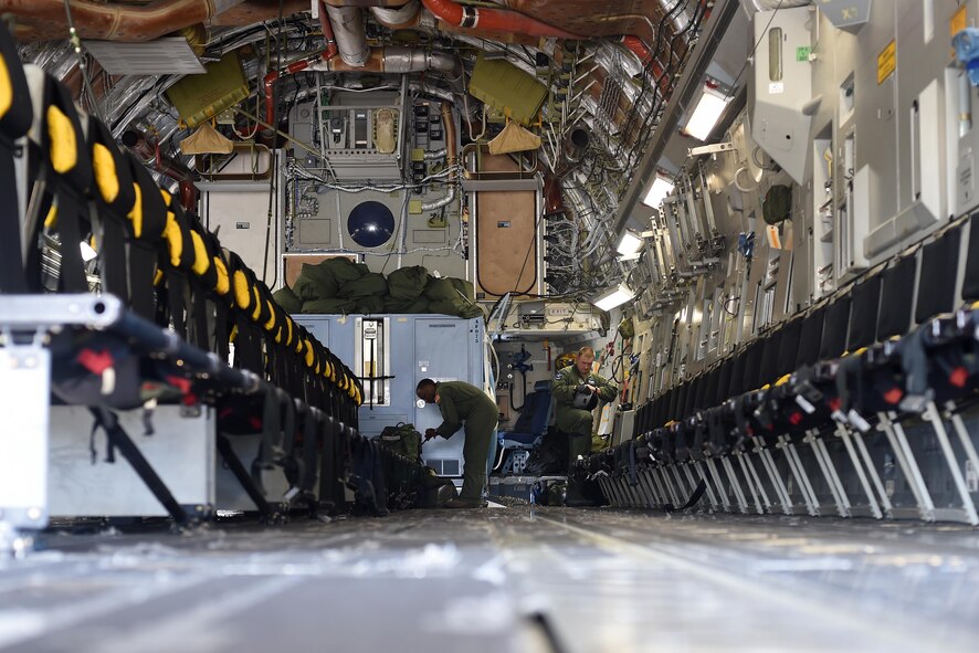 Staff Sgt. Seth Lewis (left) and Senior Airman Mike Longo (right), 7th Airlift Squadron C-17 Globemaster III loadmasters, conduct pre-flight check lists at Pope Army Air Field, North Carolina, June 4, 2016. Seven C-17’s air dropped more than 600 Soldiers over the Pope Army Airfield Range for training. (U.S. Air Force photo/Staff Sgt. Naomi Shipley)