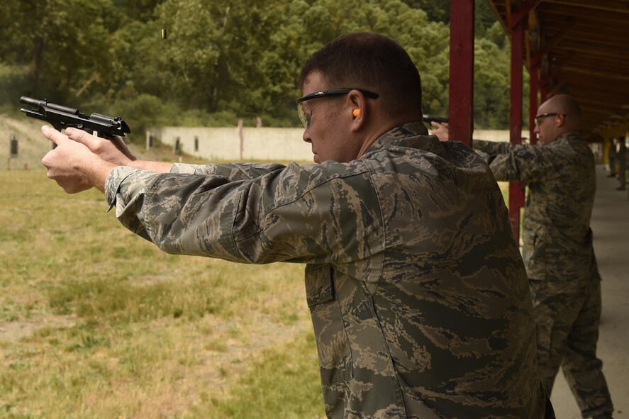 Capt. Douglas Arnett, 62nd Airlift Wing assistant staff judge advocate, fires an M9 pistol during the Excellence-in-Competition event June 2, 2016, on the range at Joint Base Lewis-McChord, Wash.  109 shooters competed in the EIC, with the top 10 percent earning a marksmanship badge.  (U.S. Air Force photo/Tech. Sgt. Tim Chacon)  