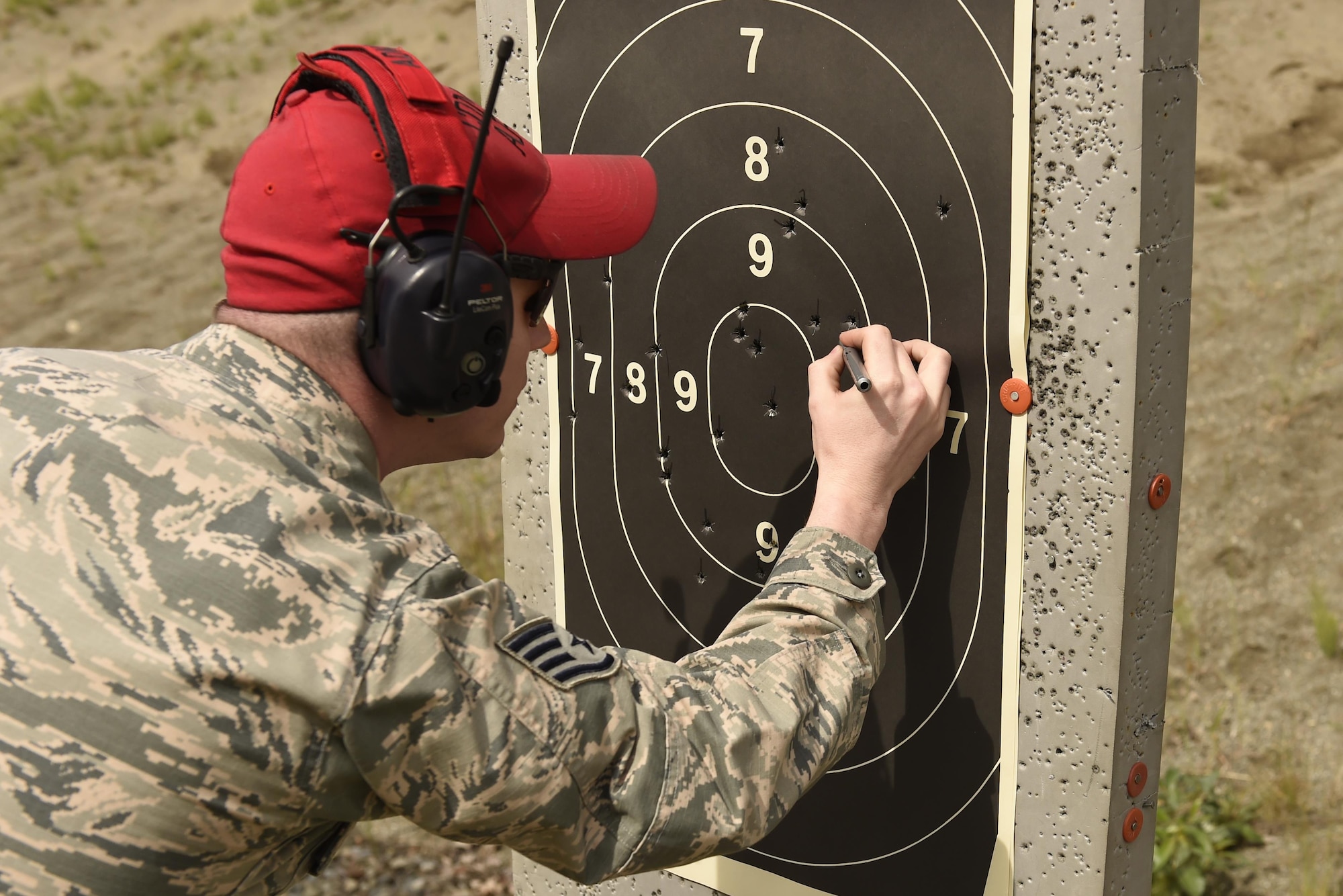 SSgt Dustin Adkins, 627th Security Forces Squadron combat arms instructor, scores a target sheet during the Excellence-in-Competition event June 2, 2016, on the range at Joint Base Lewis-McChord, Wash. Competitors in the shooting event had 30 rounds to fire, with a maximum possible score of 300. (U.S. Air Force photo/Tech. Sgt. Tim Chacon) 