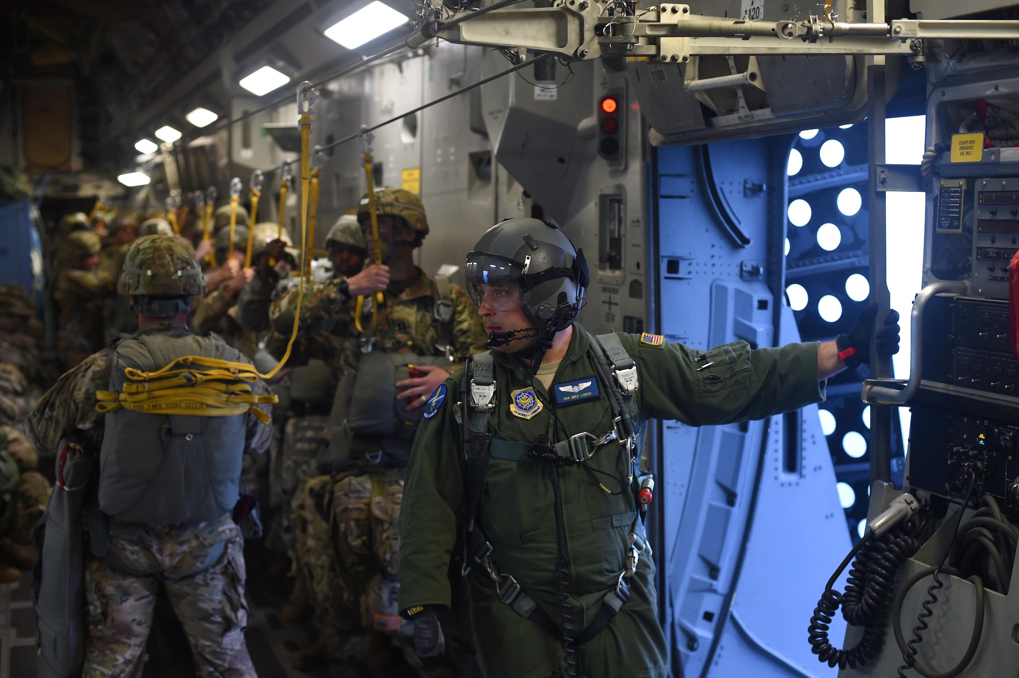 Senior Airman Mike Longo, 7th Airlift Squadron C-17 loadmaster, prepares for a personnel air drop over the Pope Army Air Field Range, North Carolina, June 4, 2016. Longo was one of three loadmasters on the aircraft ensuring the 90 Soldiers conducted a safe static line jump. (U.S. Air Force photo/Staff Sgt. Naomi Shipley)