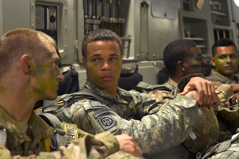 82nd Airborne Soldiers talk to each other inside a C-17 Globemaster III at Pope Army Air Field, North Carolina, June 4, 2016 prior to a parachute jump. The 62nd Airlift Wing provided three of the seven C-17’s needed to transport and air drop the more than 600 Soldiers. (U.S. Air Force photo/Staff Sgt. Naomi Shipley)