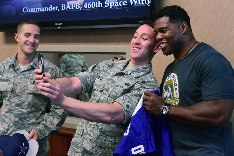 Tech. Sgt. Michael Boyd, 460th Space Wing commander’s action group, takes a selfie with Herschel Walker, former National Football League running back, June 8, 2016, at the wing headquarters building on Buckley Air Force Base, Colo. Walker visited Buckley to show his appreciation for military members and speak about his own life experiences. (U.S. Air Force photo by Airman 1st Class Luke W. Nowakowski/Released) 
