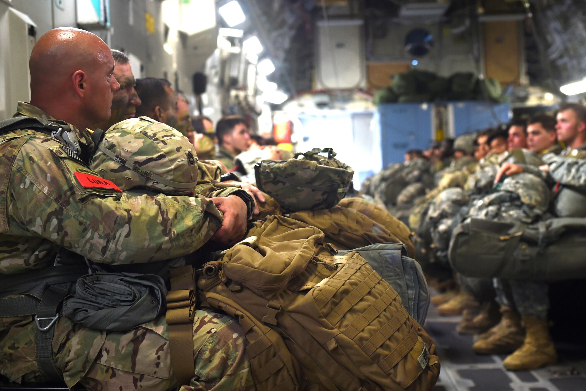 82nd Airborne Soldiers prepare to jump out of a C-17 Globemaster III at Pope Army Air Field, North Carolina, June 4, 2016. Seven C-17’s loaded approximately 90 Soldiers to conduct a personnel air drop over the range for training prior to departing for a large scale exercise in Europe. (U.S. Air Force photo/Staff Sgt. Naomi Shipley)