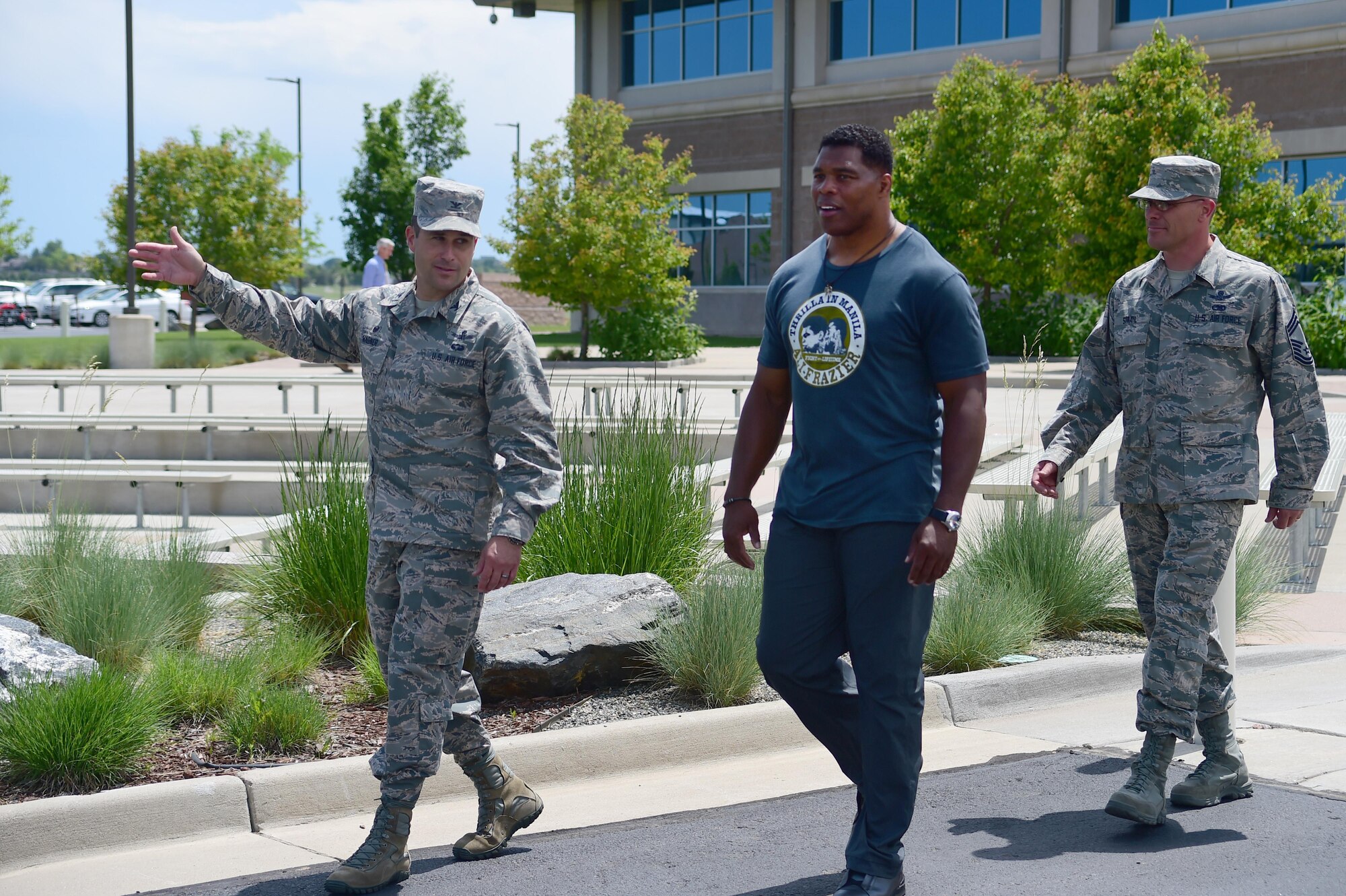Col. John Wagner, 460th Space Wing commander, walks with Herschel Walker, former National Football League running back June 8, 2016, on Buckley Air Force Base, Colo. Walker visited Buckley in order to speak about his life experiences as well as speak of his gratitude for military members. (U.S. Air Force photo by Airman 1st Class Luke W. Nowakowski/Released)