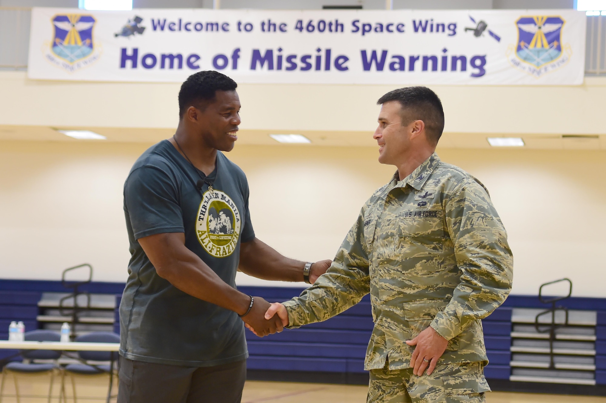 Col. John Wagner, 460th Space Wing commander, thanks Herschel Walker, former National Football League running back, for visiting the installation June 8, 2016, at the fitness center on Buckley Air Force Base, Colo. Walker visited Buckley to speak about his appreciation for military members and the struggles he’s had to overcome. (U.S. Air Force photo by Airman 1st Class Luke W. Nowakowski/Released)