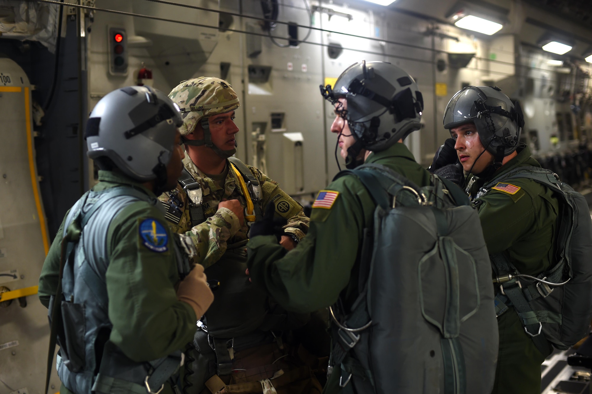 Three C-17 Globemaster III loadmasters brief an Army Soldier prior to a static line jump over the Pope Army Air Field Range, North Carolina on June 4, 2016. The three loadmasters worked together to ensure the 90 Soldiers safely conducted the jump. (U.S. Air Force photo/Staff Sgt. Naomi Shipley)