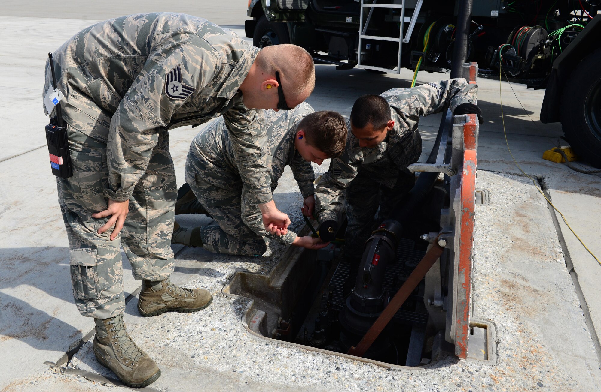 Staff Sgt. William White, the 354th Logistics Readiness Squadron noncommissioned officer in charge of fuels distribution, assists a new Airman in preparing to refuel an aircraft, June 7, 2016, at Eielson Air Force Base, Alaska. RED FLAG-Alaska 16-2 is in full swing and fuels Airmen are on the flight line all day to provide support to all U.S. and foreign partner units participating in the Pacific Air Forces commander-directed exercise. (U.S. Air Force photo by Airman 1st Class Cassandra Whitman/Released)