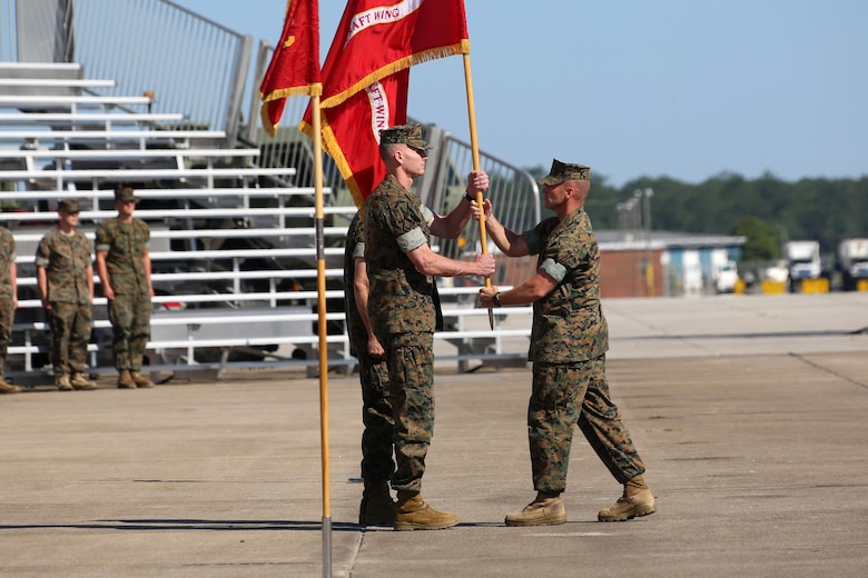 Former 2nd Marine Aircraft Wing commanding general, Maj. Gen. Gary L. Thomas, left, passes the 2nd MAW colors to Sgt. Maj. Richard D. Thresher during the 2nd MAW change of command ceremony at Marine Corps Air Station Cherry Point, N.C., June 9, 2016. Thomas relinquished his post as the 2nd MAW commanding general to Brig. Gen. Matthew G. Glavy during the ceremony. Thresher is the 2nd MAW sergeant major. (U.S. Marine Corps photo by Cpl. N. W. Huertas/Released)