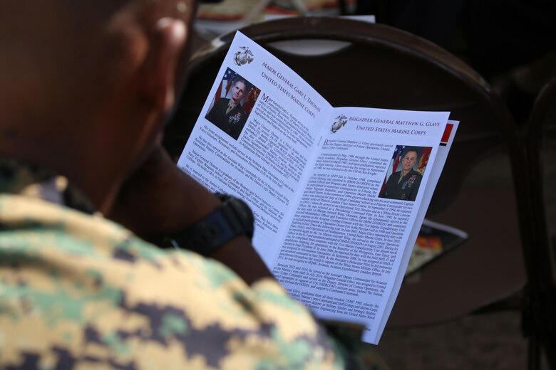 A Marine reads the biographies of the Maj. Gen. Gary L. Thomas and Brig. Gen. Matthew G. Glavy during the 2nd Marine Aircraft Wing change of command ceremony at Marine Corps Air Station Cherry Point, N.C., June 9, 2016. Thomas relinquished his post as the 2nd MAW commanding general to Glavy during the ceremony. (U.S. Marine Corps photo by Cpl. N. W. Huertas/Released)