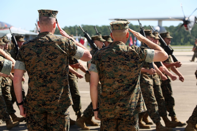 Maj. Gen. Gary L. Thomas, left, and Brig. Gen. Matthew G. Glavy salute passing troops during the 2nd Marine Aircraft Wing change of command ceremony at Marine Corps Air Station Cherry Point, N.C., June 9, 2016. Thomas relinquished his post as the 2nd MAW commanding general to Glavy during the ceremony. (U.S. Marine Corps photo by Cpl. N. W. Huertas/Released)