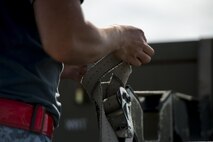 Republic of Singapore Air Force (RSAF) ME1 Ang Yann Chang, a 425th Aircraft Maintenance Unit (AMU) weapons load technician assigned to Luke Air Force Base, Ariz., loosens munitions tie-downs prior to loading them onto an RSAF F-16 Fighting Falcon for an afternoon sortie June 7, 2016, on the Eielson Air Force Base, Alaska, flight line. The 67,000 square miles of airspace available in the Joint Pacific Alaska Range Complex provides unparalleled training opportunities for units assigned to RF-A 16-2 to exchange practices and procedures in a controlled environment. (U.S. Air Force photo by Capt. Elias Zani/Released)