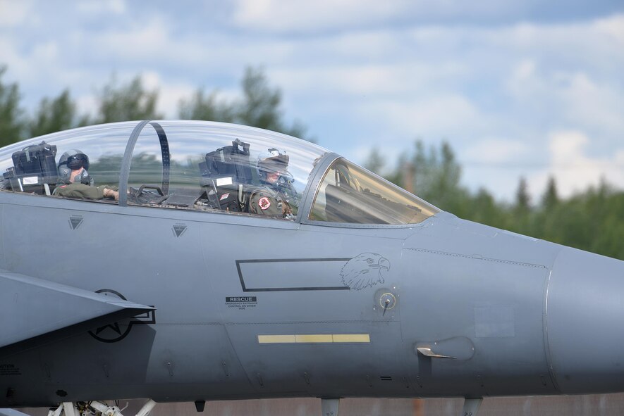 A U.S. Air Force F-15E Strike Eagle pilot and weapon systems officer assigned to the 494th Fighter Squadron out of Royal Air Force Lakenheath, England, look over as they taxi down the Eielson Air Force Base, Alaska, flight line in their all-weather, highly maneuverable, dual-role fighter June 6, 2016, during RED FLAG-Alaska (RF-A) 16-2. RF-A is a series of Pacific Air Forces commander-directed field training exercises that provides unique opportunities to integrate various forces like the Liberty Wing into joint, coalition and multilateral training from simulated forward operating bases. (U.S. Air Force photo by Master Sgt. Karen J. Tomasik/Released)