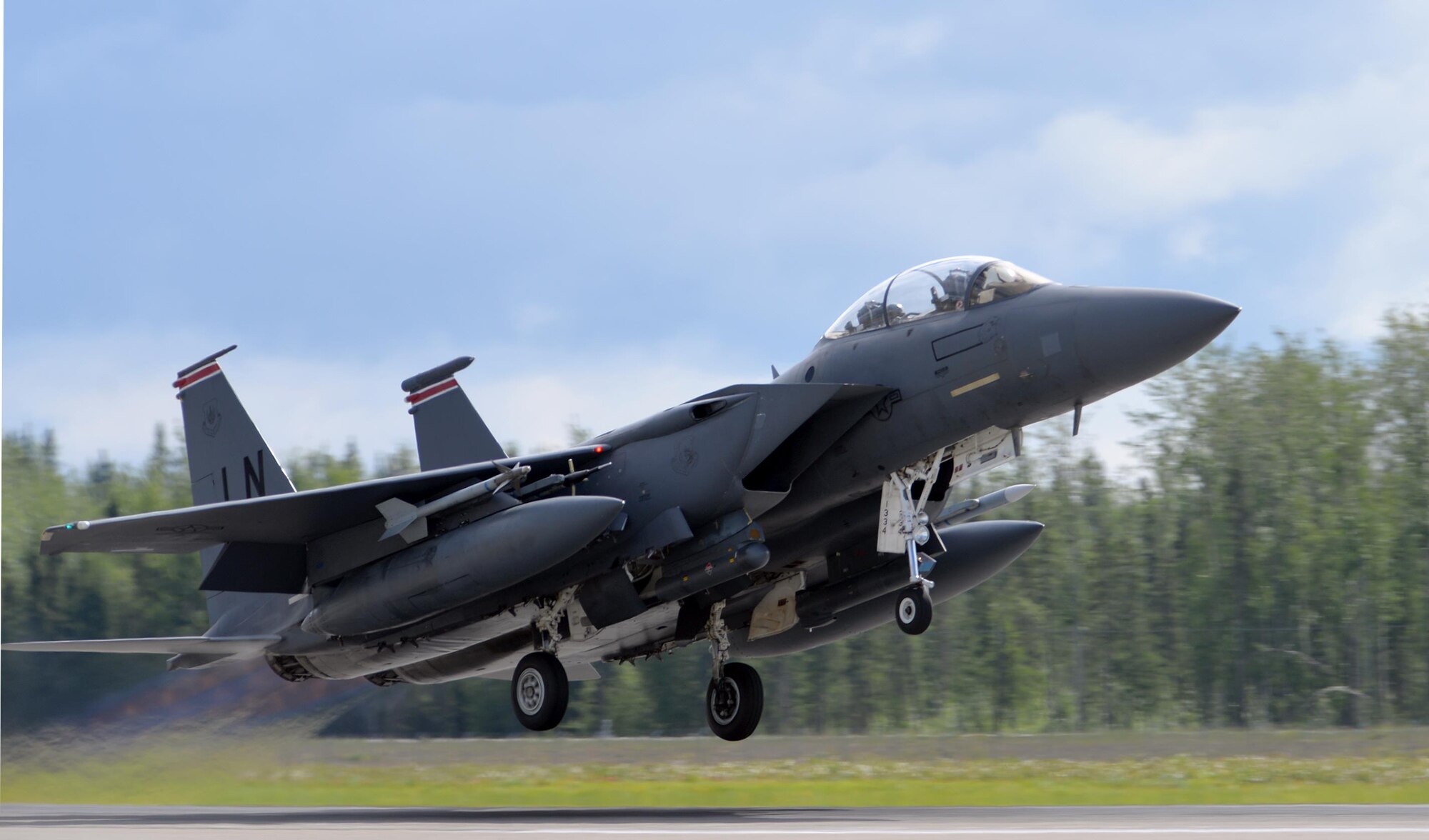 A U.S. Air Force F-15E Strike Eagle all-weather, highly maneuverable, dual-role fighter assigned to the 494th Fighter Squadron out of Royal Air Force Lakenheath, England, gains speed as it lifts off from the Eielson Air Force Base, Alaska, runway June 6, 2016, during RED FLAG-Alaska (RF-A) 16-2. RF-A missions are conducted over the Joint Pacific Alaska Range Complex, more than 67,000 square miles of airspace that includes one conventional bombing range and two tactical bombing ranges containing 510 different types of targets and 45 threat simulators, providing units like the Liberty Wing a realistic training environment in the largest instrumented air, ground and electronic combat training range in the world. (U.S. Air Force photo by Master Sgt. Karen J. Tomasik/Released)