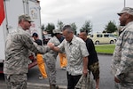 U.S. Air Force Staff Sgt. Jamie Smith, Air Force Sergeants Association Chapter 1553 vice president and 31st Rescue Squadron resource advisor, exchanges a goodbye with Yoshihiko Nishime, pastor of Yugafu Church, after assisting with an outreach project, June 2, 2016, at Kadena Air Base, Japan. Yugafu Church partners with Promise Keepers, a local non-profit organization, in caring for the homeless and needy in the surrounding community. 