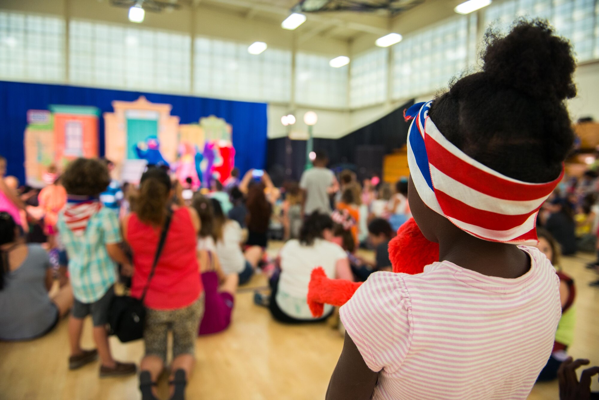 Members of Travis Air Force Base, Calif., enjoy the performance of the Sesame Street USO Experience for Military Families at the base gym June 6, 2016. (U.S. Air Force photo by Louis Briscese/Released)   
