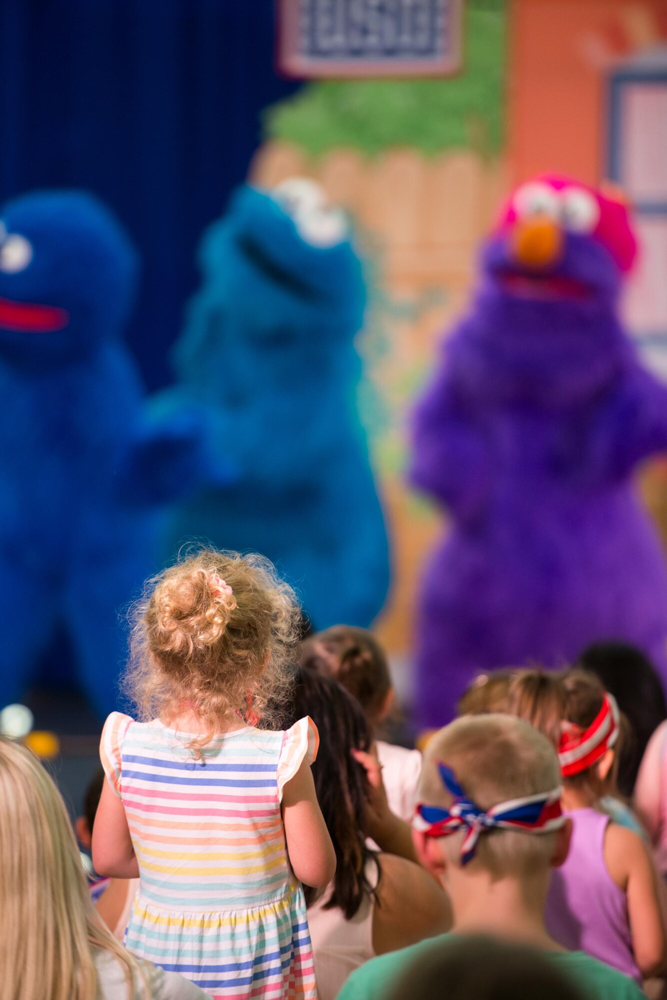 Members of Travis Air Force Base, Calif., enjoy the performance of the Sesame Street USO Experience for Military Families at the base gym June 6, 2016. (U.S. Air Force photo by Louis Briscese/Released)   