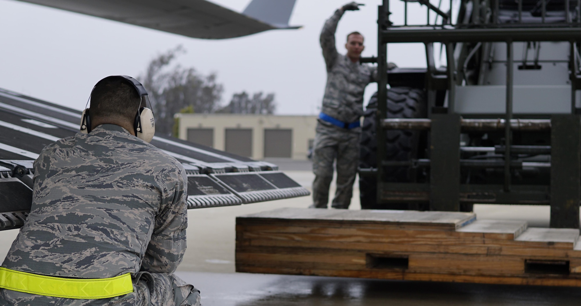 Tech. Sgt. Kenneth Cumbie, 30th Logistics Readiness Squadron air terminal section chief, and Staff Sgt. Nickolas Jordan, 30th LRS air terminal NCOIC, guide a forklift to place a ramp behind the C-17 Globemaster III, May 19, 2016, Vandenberg Air Force Base, Calif. The air terminal at Vandenberg may not have the fast-paced tempo of an aircraft-centric base, but the items they move with their small crew tend to be of historical significance – most recently shipping a missile transporter for the Missile Defense Agency and Boeing, to Alaska, with a repaired interceptor missile aboard.  
