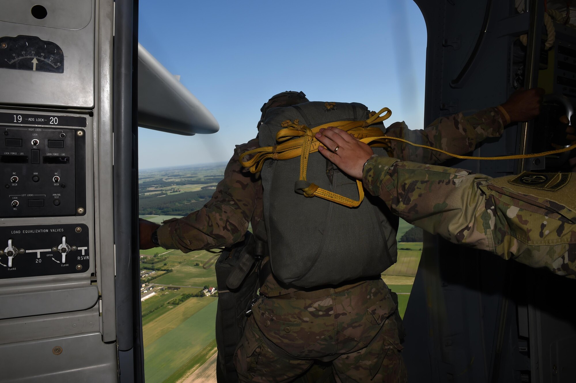An 82nd Airborne Division Paratrooper looks out the side door of a C-17 Globemaster III over Poland June 6, 2016. The Soldier was one of hundreds being air dropped into Poland for Exercise Swift Response 2016. (Air Force photo/Staff Sgt. Naomi Shipley)