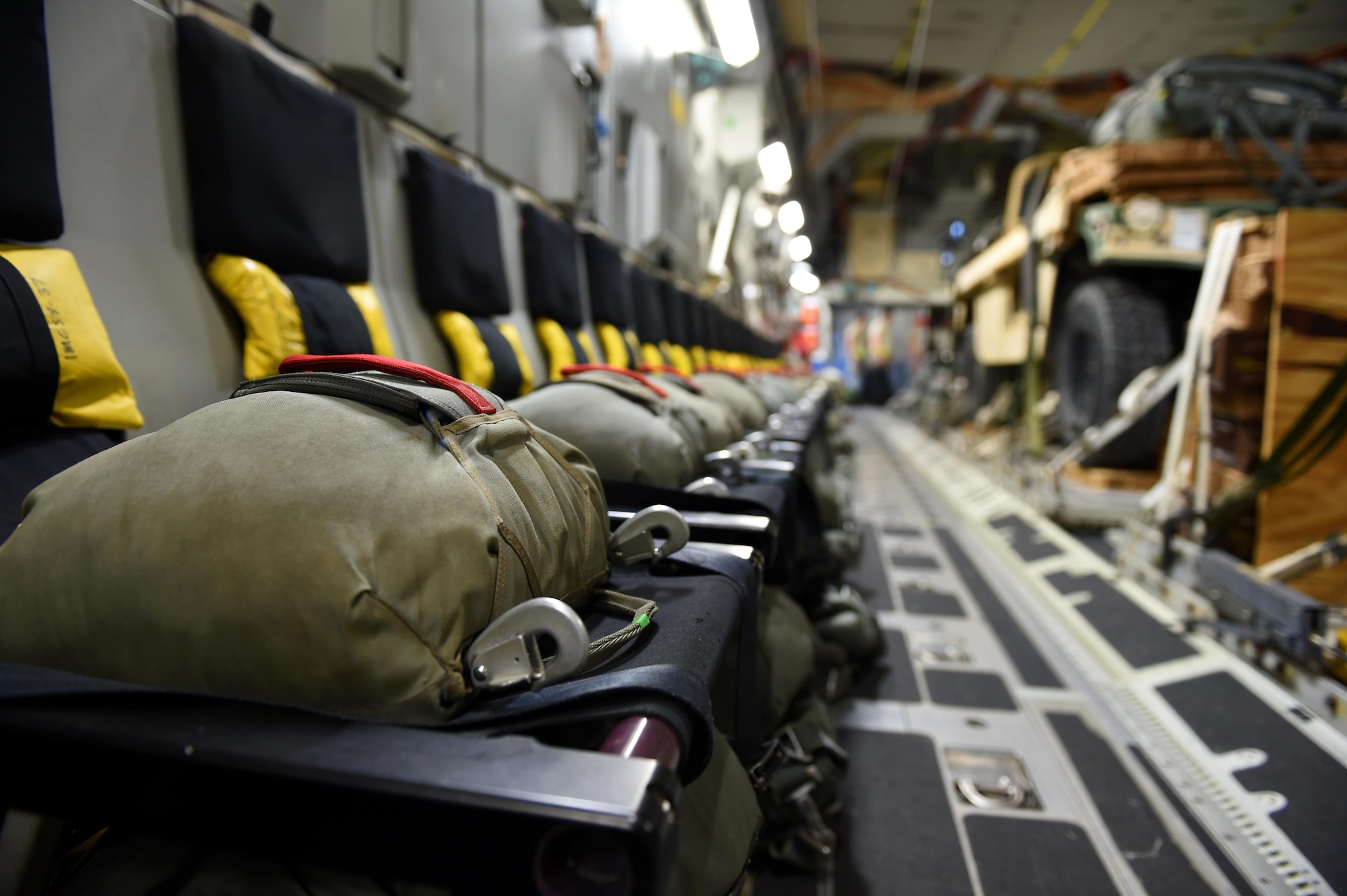 Parachutes line the seats inside a 62nd Airlift Wing C-17 Globemaster III at Pope Army Air Field, N.C., on June 6, 2016. More than 80 Paratroopers with the 82nd Airborne Division, British and Polish Forces conducted a static line jump from the C-17 over Poland during Exercise Swift Response. (Air Force photo/Staff Sgt. Naomi Shipley)