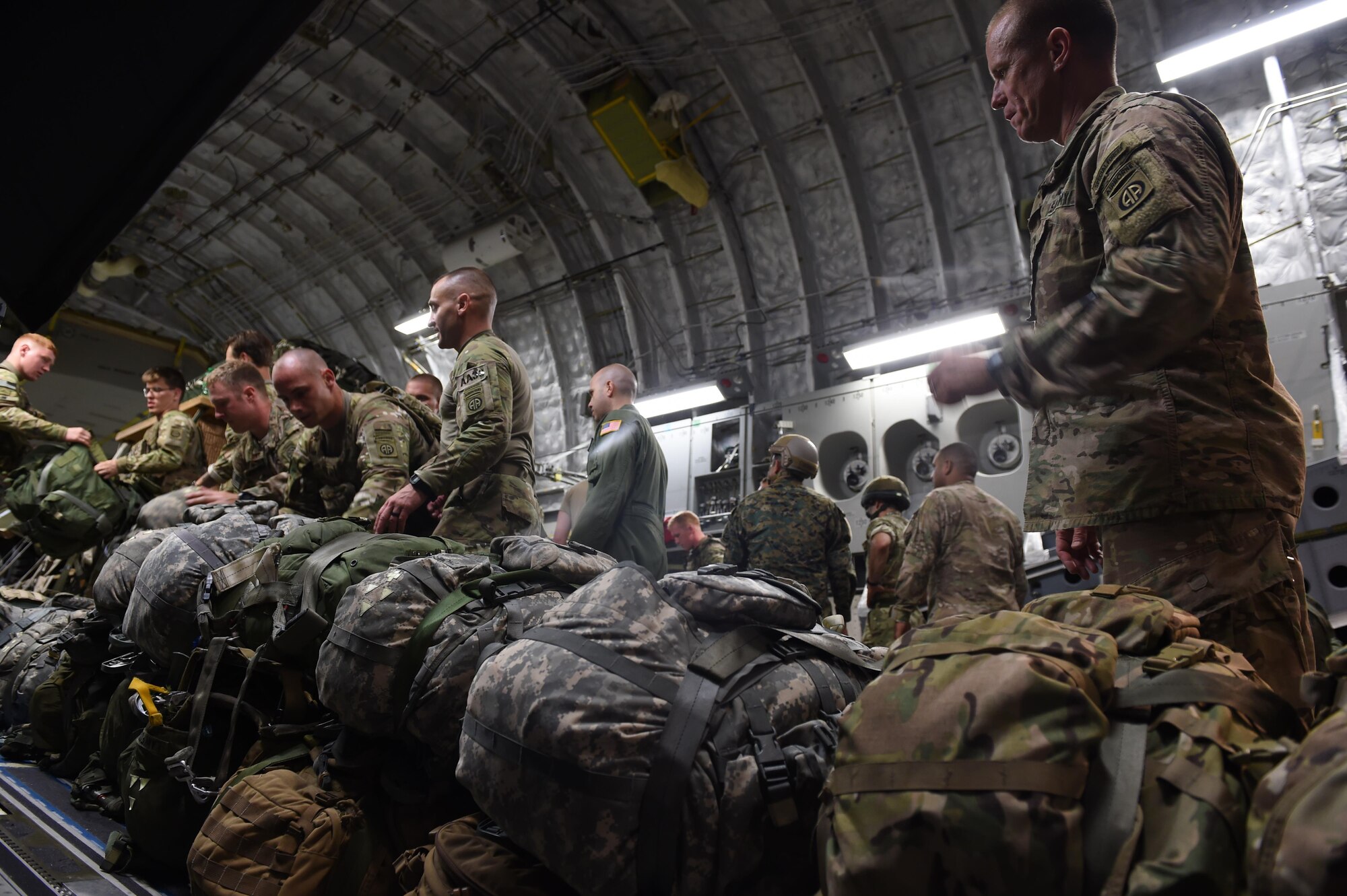 Paratroopers with the 82nd Airborne Division load their equipment into a 62nd Airlift Wing C-17 Globemaster III on Pope Army Air Field, N.C. on June 6, 2016. More than 80 paratroopers from U.S., British and Polish Forces jumped from the C-17 into Poland as part of Exercise Swift Response 2016. (Air Force photo/Staff Sgt. Naomi Shipley)