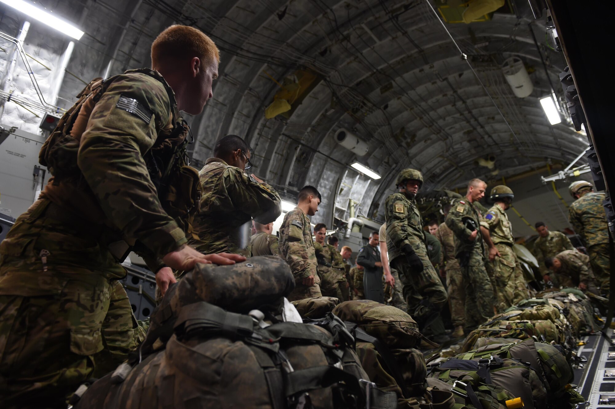 Paratroopers with the 82nd Airborne Division load their equipment into a 62nd Airlift Wing C-17 Globemaster III on Pope Army Air Field, N.C. on June 6, 2016. More than 80 paratroopers from U.S., British and Polish Forces jumped from the C-17 into Poland as part of Exercise Swift Response 2016. (Air Force photo/Staff Sgt. Naomi Shipley)