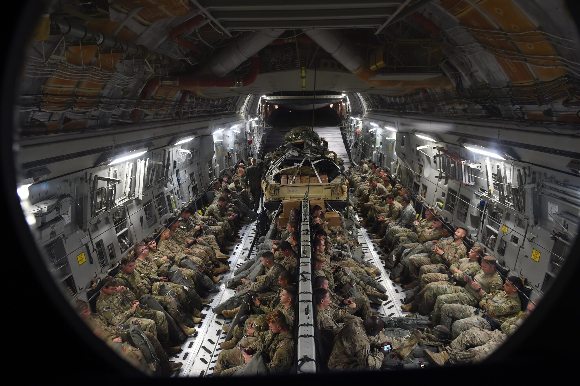 Soldiers with the 82nd Airborne Division along with British and Polish Forces sit inside a 62nd Airlift Wing C-17 Globemaster III on Pope Army Air Field, N.C., on June 6, 2016. More than 80 Paratroopers flew from Pope to Poland to participate in Exercise Swift Response 2016. (Air Force photo/Staff Sgt. Naomi Shipley)
 
