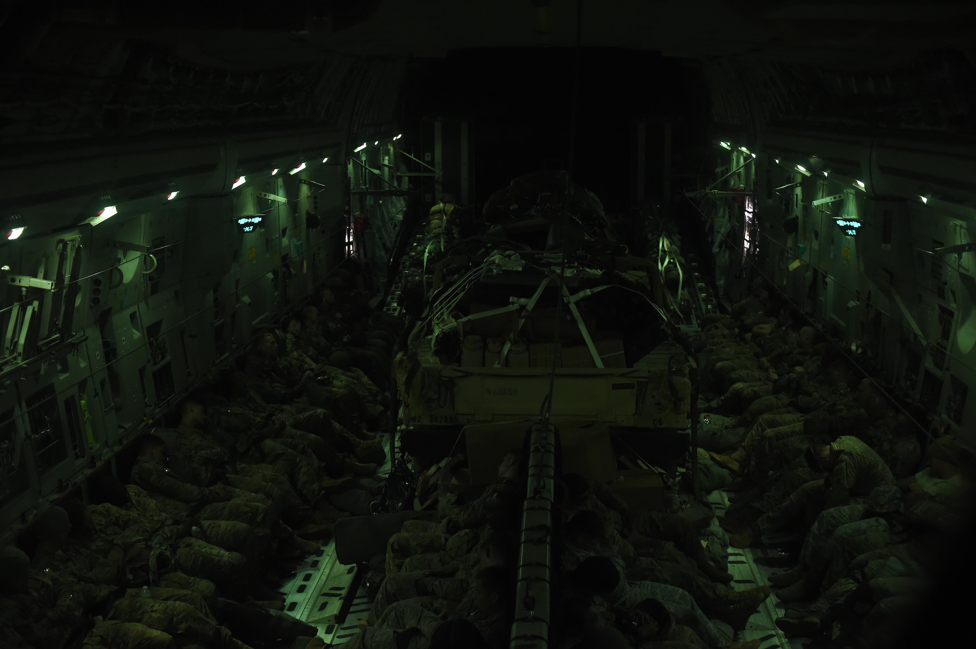 Soldiers with the 82nd Airborne Division along with British and Polish Forces sleep during a nine-hour flight to Poland on June 6, 2016. More than 80 Paratroopers flew on the 62nd Airlift Wing C-17 Globemaster III from Pope Army Air Field, N.C., to Poland in support of Exercise Swift Response 2016. (Air Force photo/Staff Sgt. Naomi Shipley)