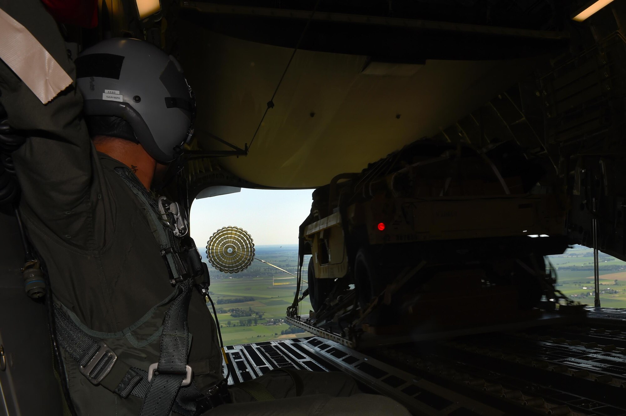 An Army Humvee is dropped into Poland on June 6, 2016, from a 62nd Airlift Wing C-17 Globemaster III. The Humvee was used by 82nd Airborne Division paratroopers to conduct tactical training on the ground during Exercise Swift Response 2016. (Air Force photo/Staff Sgt. Naomi Shipley)