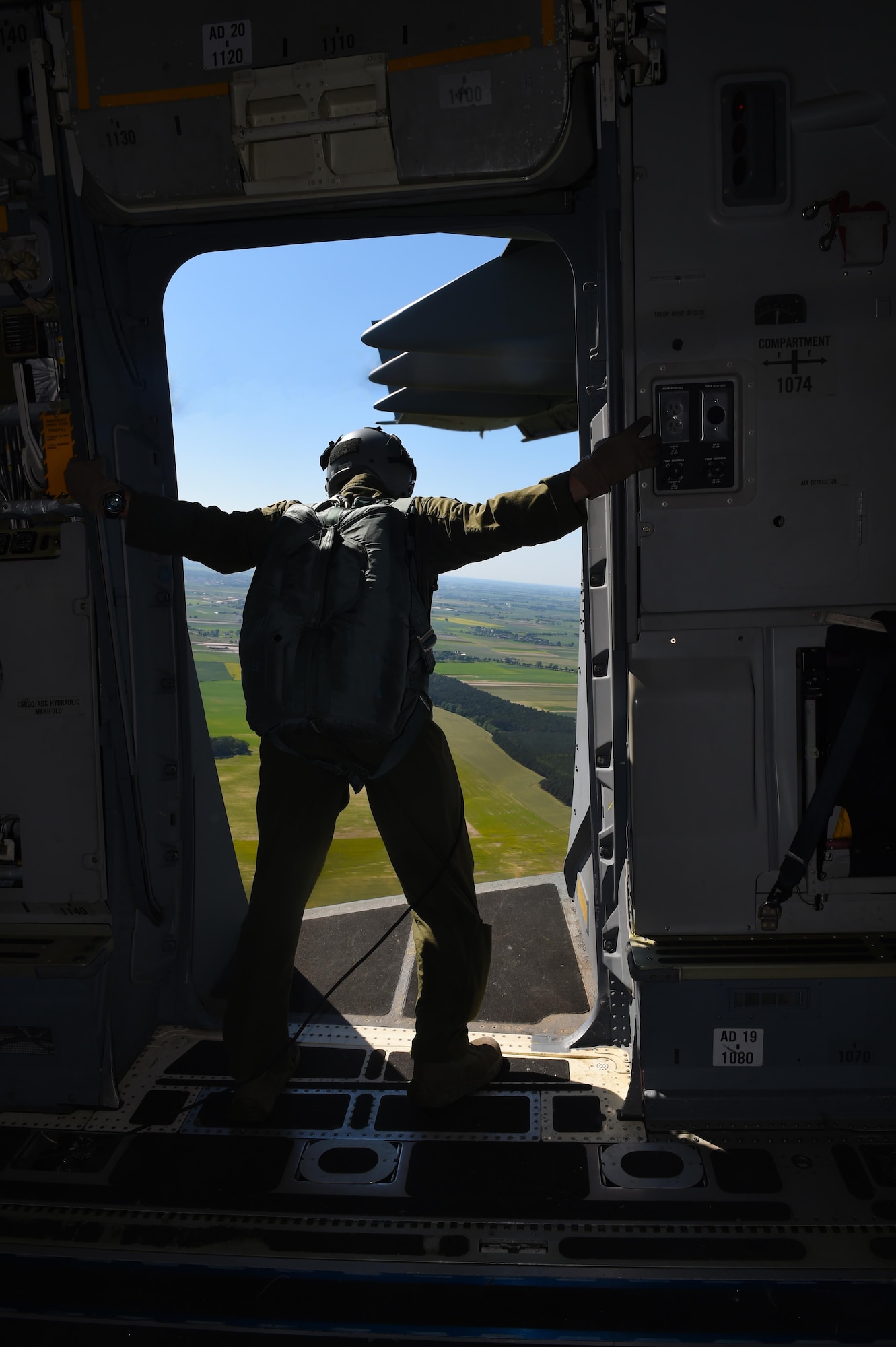 Tech. Sgt. Paul Mooney, 8th Airlift Squadron C-17 Globemaster III loadmaster, looks over the drop zone in Poland June 6, 2016. Mooney was part of one of the three 62nd Airlift Wing’s units participating in Exercise Swift Response 2016. Mooney loaded and secured a C-17 with equipment and personnel for air drop operations. (Air Force photo/Staff Sgt. Naomi Shipley)
