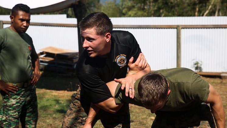 Cpl. Preston G. Thompson demonstrates mechanical advantage control holds during a non-lethal weapons course, June 7, 2016, at Metinaro, Timor Leste, as part of Exercise Crocodilo 16. The course allows Marines to instruct Timorese soldiers on less-than-lethal means to handle future disputes. Crocodilo is a multi-national, bilateral exercise designed to increase interoperability and relations with participating nations. Thompson, from Wyoming, Michigan, is a military policeman and the chief instructor for the non-lethal weapons course with Task Force Koa Moana, originally assigned to Charlie Company, 3rd Law Enforcement Battalion, III Marine Expeditionary Force.
