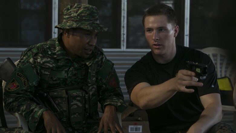 Cpl. Preston G. Thompson (Right) instructs Pvt. Fransicso Araujo how to properly operate the X26-E Taser during Exercise Crocodilo 16, June 7, 2016, at Metinaro, Timor Leste, as part of Task Force Koa Moana’s deployment to nations in the Asia-Pacific region. The task force brings capabilities in law enforcement, infantry, engineering and combat lifesaving skills to increase interoperability and relations with participating nations. Araujo is with Bravo Company, 1st Battalion, Timor Leste Defense Force. Thompson, from Wyoming, Michigan, is a military police and chief instructor for the non-lethal weapons course with Task Force Koa Moana, originally assigned to Charlie Company, 3rd Law Enforcement Battalion, III Marine Expeditionary Force.