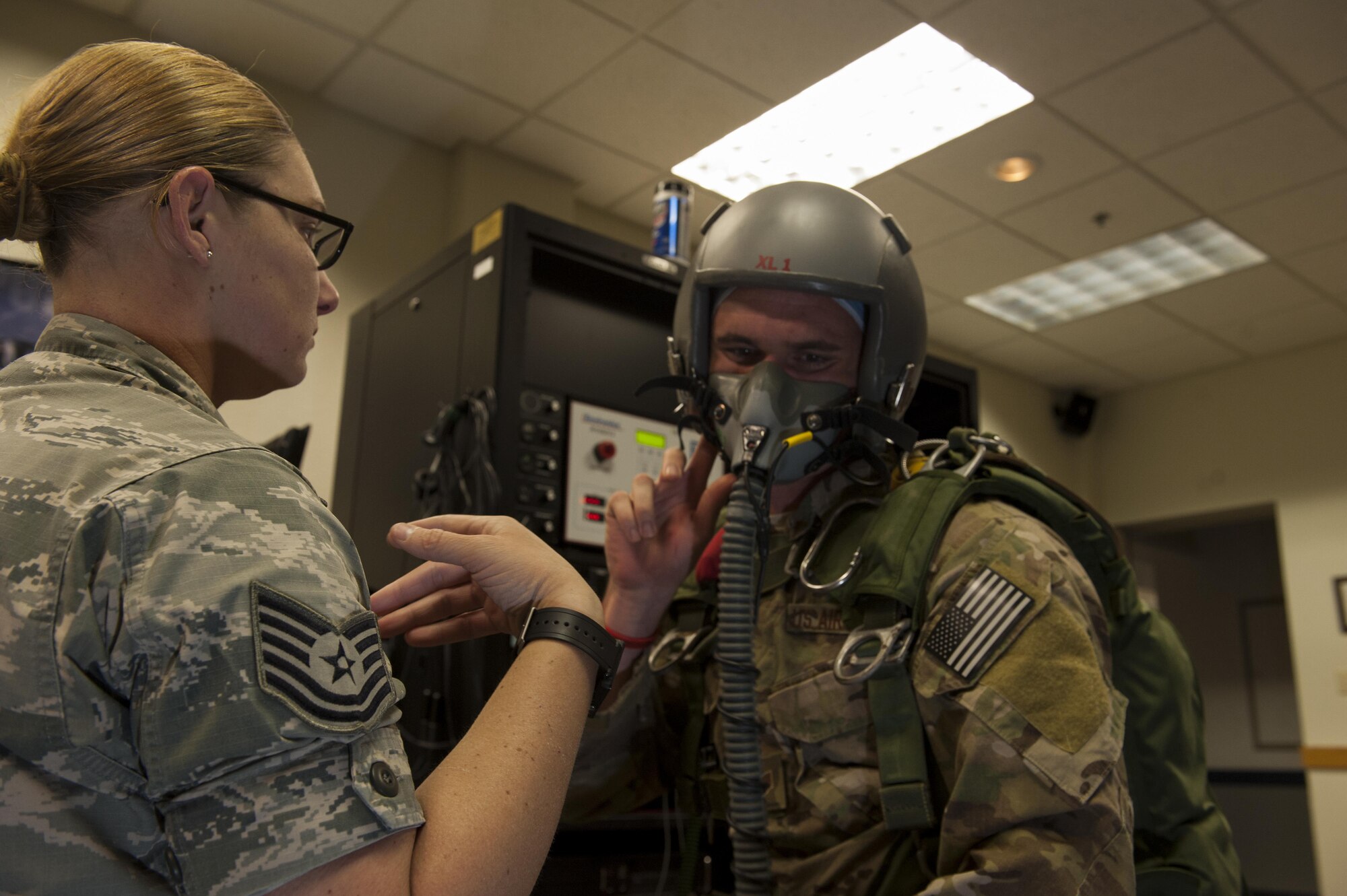 U.S. Air Force Tech. Sgt. Charrissa Smith, 18th Aerospace Medicine Squadron aerospace physiology technician, verbally instructs Tech. Sgt. Robert Watkins, 320th Special Tactics Squadron pararescueman, as he uses a Reduced Oxygen Breathing Device (ROBD), June 8, 2016, at Kadena Air Base, Japan. The ROBD simulates a high altitude environment, allowing both the participant and the instructor to look out for symptoms of hypoxia. (U.S. Air Force photo by Airman 1st Class Lynette M. Rolen)